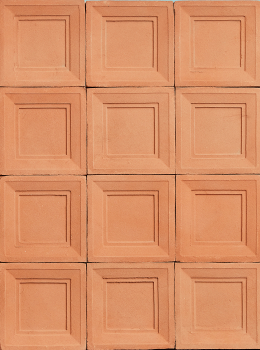 Rivestimento murale con piastrelle quadrate in terracotta con cornice in rilievo